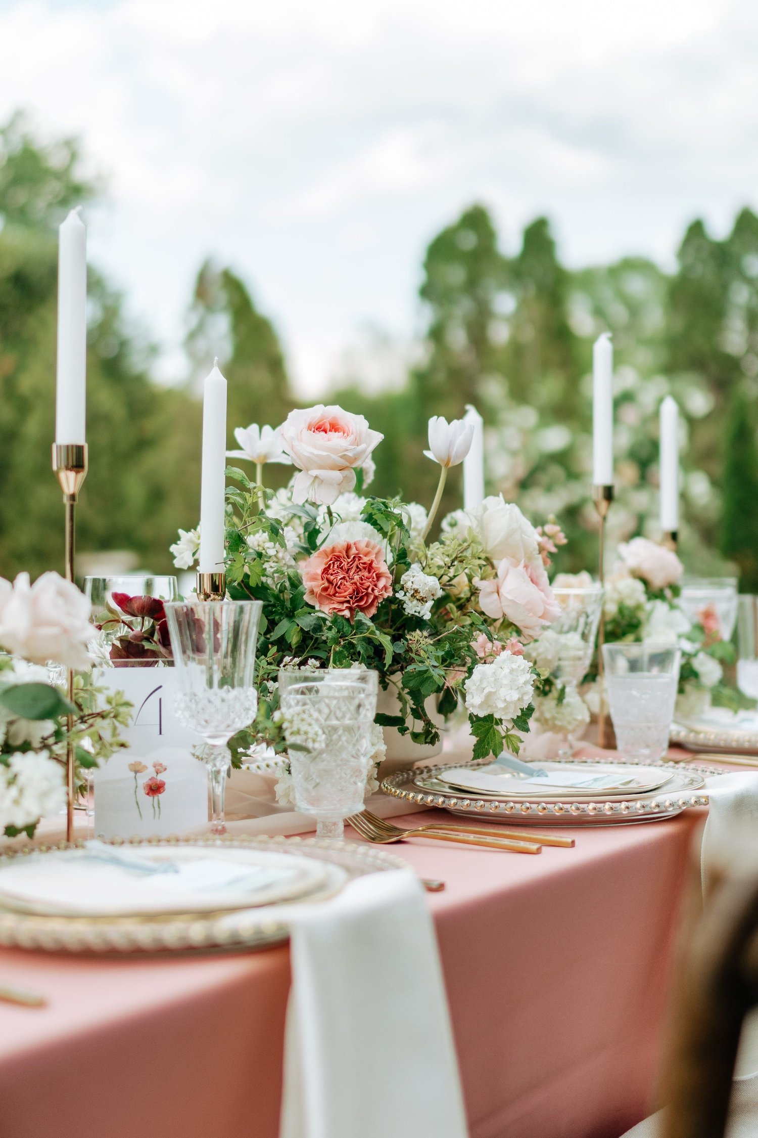 Wedding couple beneath a floral arbor